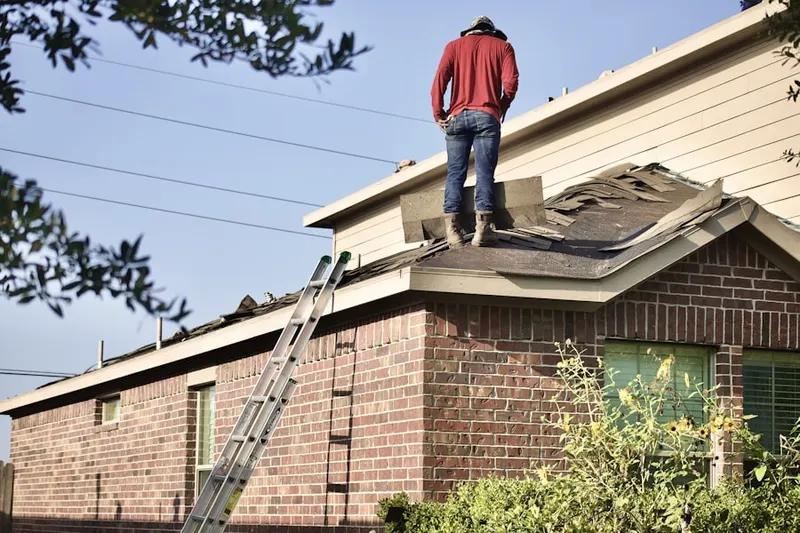Professional roofer working on a residential roof in Rolling Knolls